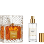 Lattafa Khamrah perfume bottle with matching fragrance decant spray and gold cap on a black background.